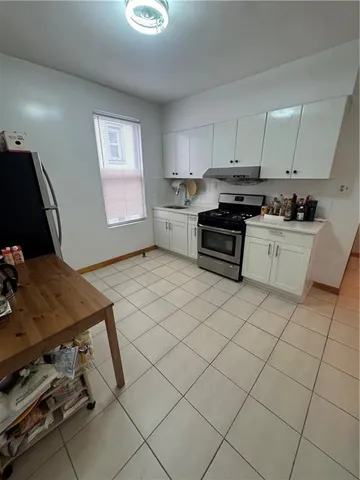 a kitchen with a stove a sink and a refrigerator