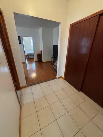 a view of a livingroom with wooden floor and furniture