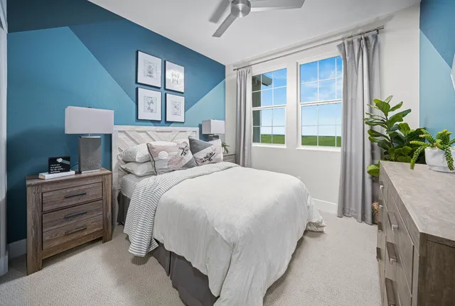 a bedroom with a bed and a potted plant
