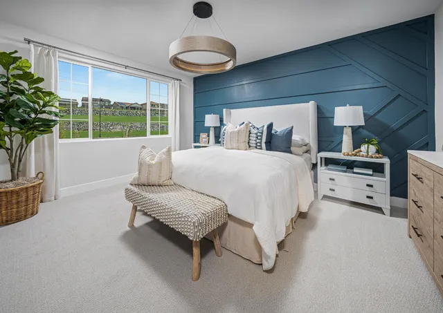 a bedroom with a bed and a potted plant