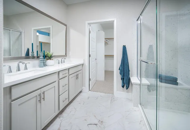 a spacious bathroom with a double vanity sink and a mirror