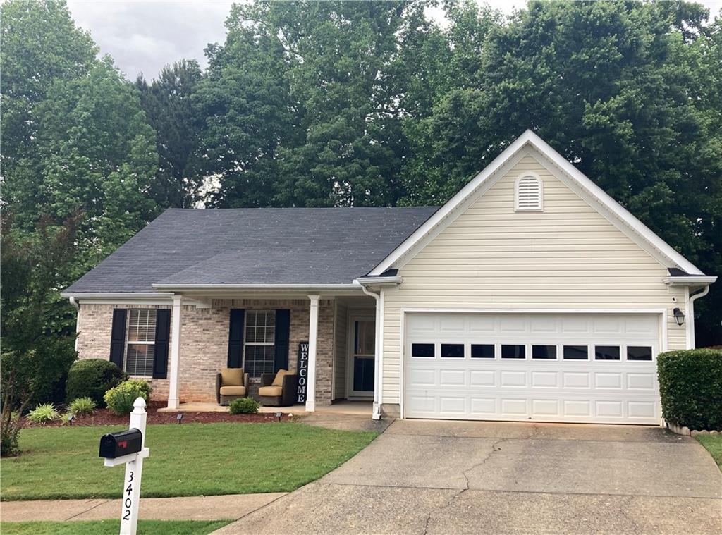 a view of a house with a yard and plants