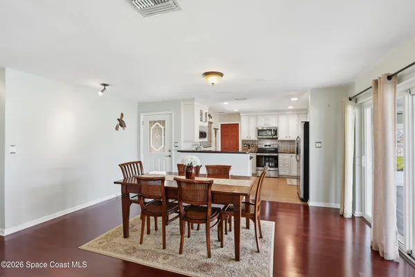 a view of a dining room with furniture and wooden floor
