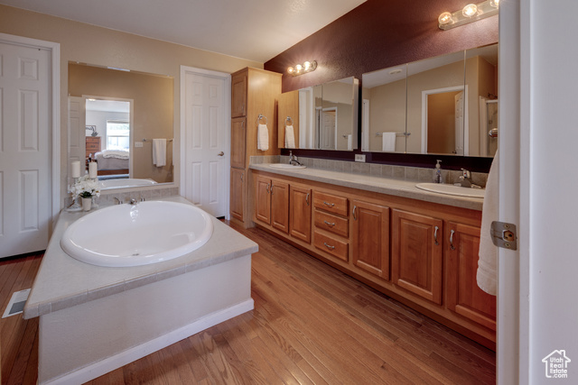 33 Merriam Court Moab, UT 84532 - Photo 18 of 56 Ensuite bathroom with a stall shower, soaking tub, double vanities, large walk-in closet, and lots of storage