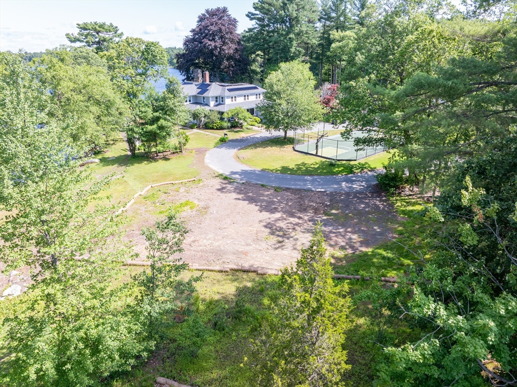 14 Geneva Road Andover, MA 01810 - Photo 24 of 36 a view of a swimming pool with a yard and trees in the background