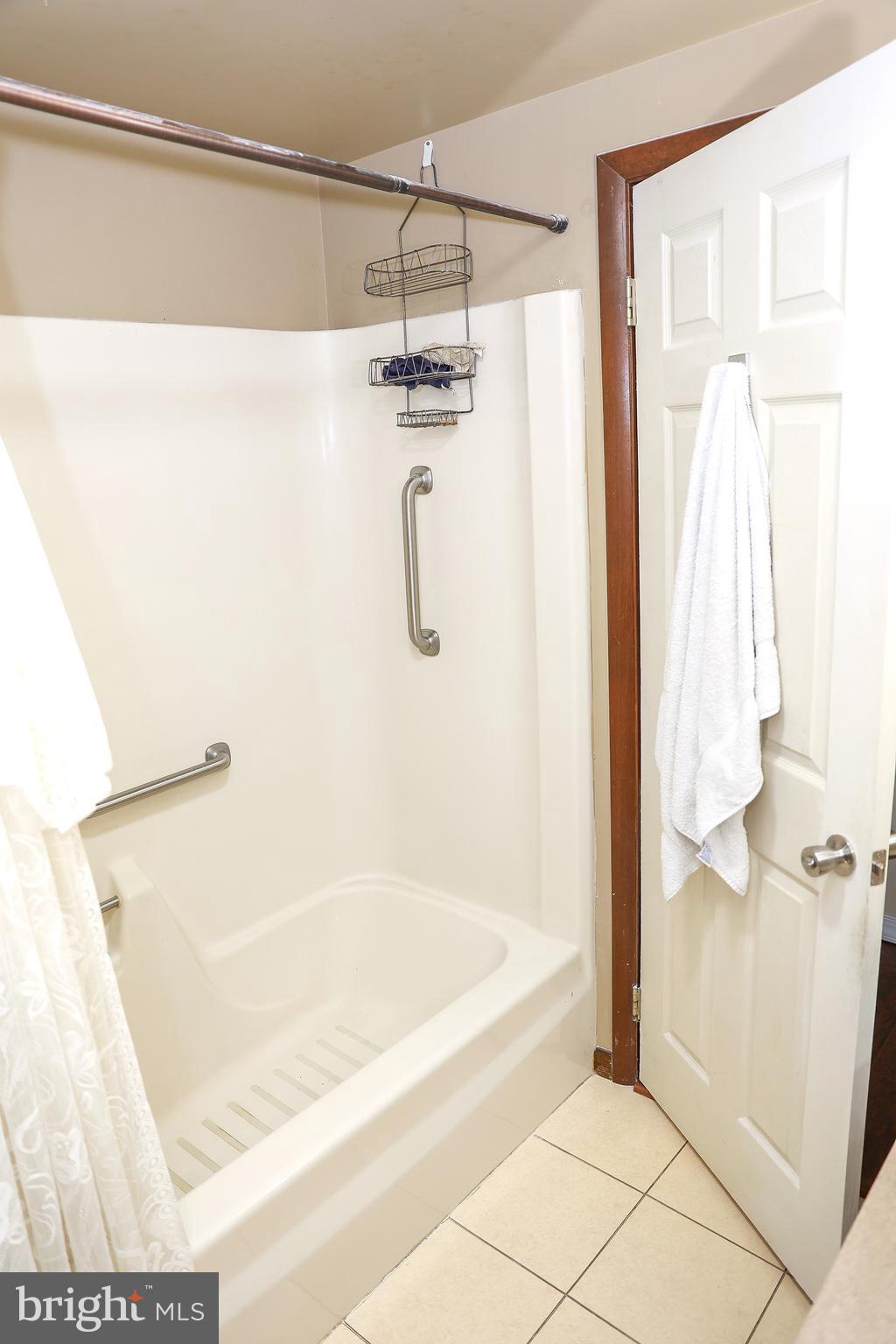 57 Fairview Road Belleville, PA 17004 - Photo 12 of 36 a bathroom with a shower and a bath tub