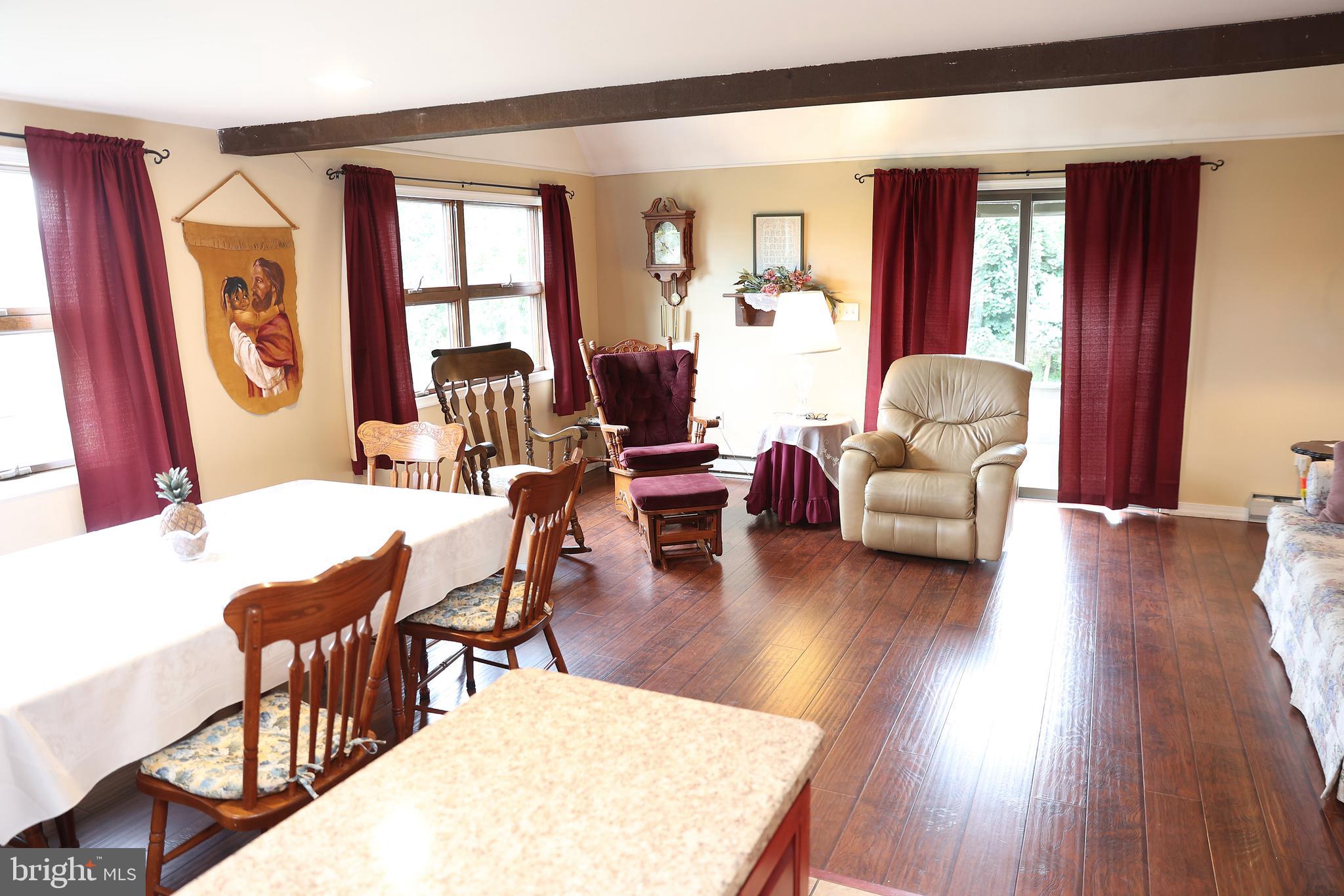 57 Fairview Road Belleville, PA 17004 - Photo 20 of 36 a living room with furniture a large window and wooden floor
