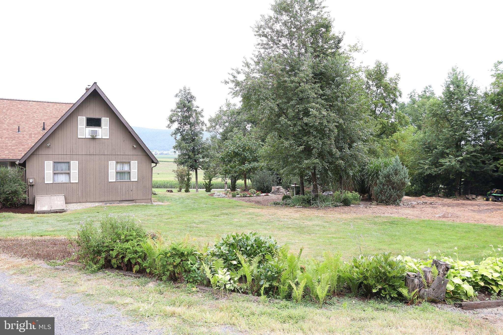 57 Fairview Road Belleville, PA 17004 - Photo 3 of 36 a view of a yard in front of a house with large trees