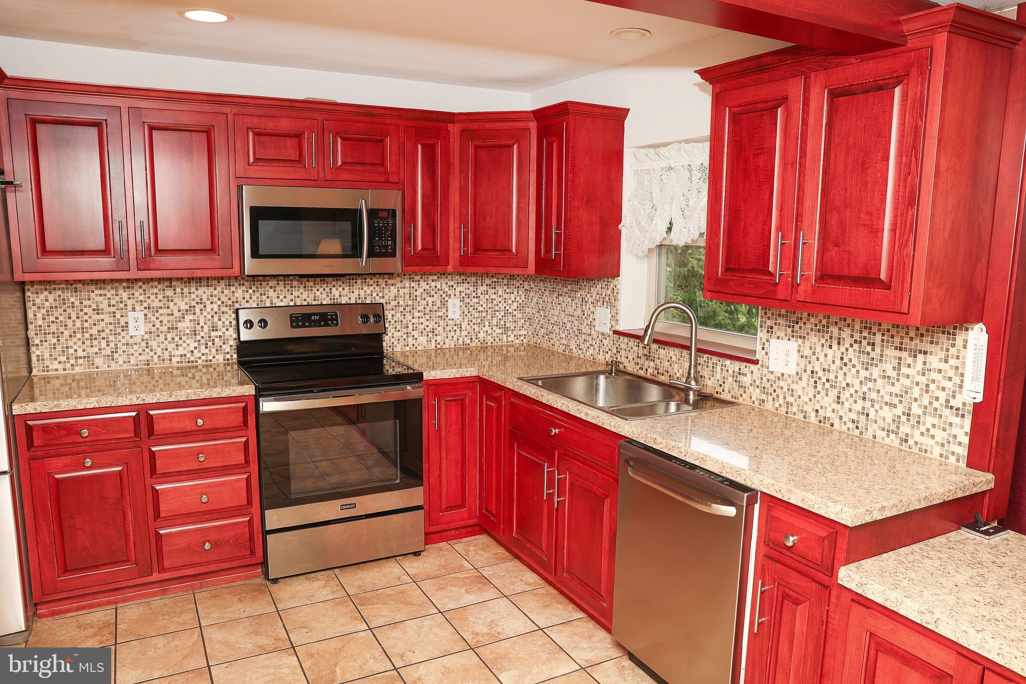 57 Fairview Road Belleville, PA 17004 - Photo 34 of 36 a kitchen with stainless steel appliances granite countertop a stove sink microwave and cabinets