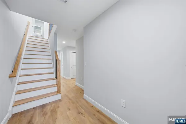 a view of a hallway with stairs