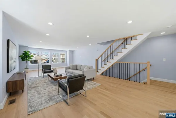 a living room with furniture and stairs