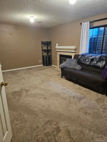 a bedroom with a bed and a fireplace