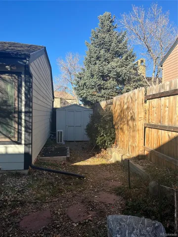 a view of a backyard with large trees
