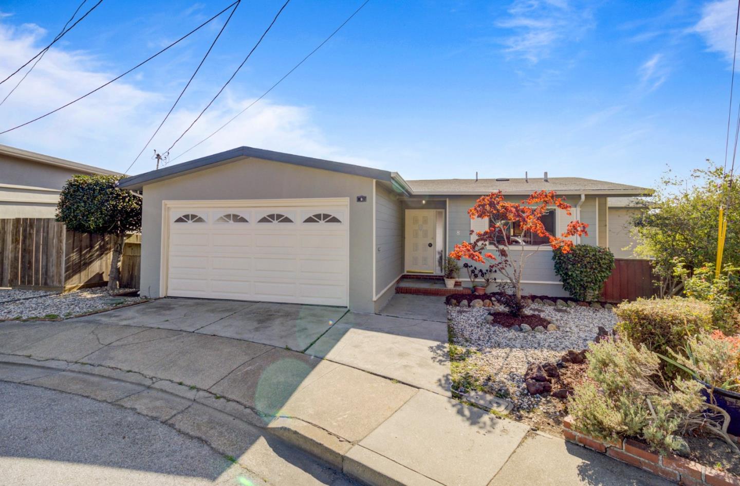 a view of a patio with table and chairs under an umbrella