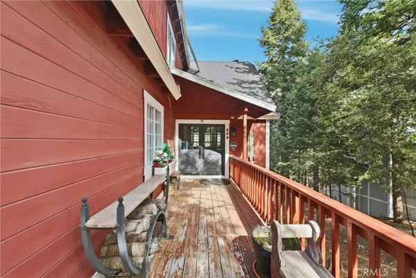 a view of balcony with wooden floor and fence