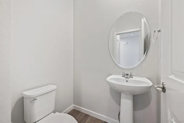 a bathroom with a sink a mirror and a toilet