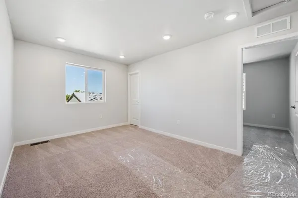 an empty room with cabinet and a window
