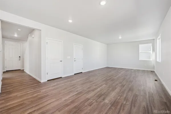 an empty room with wooden floor