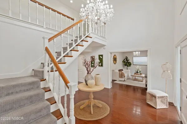 a kitchen with stainless steel appliances a refrigerator a sink and wooden floors