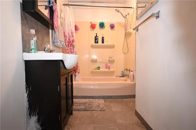 a bathroom with a bathtub and a sink