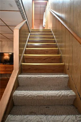 a bedroom with a large bed and a wooden door