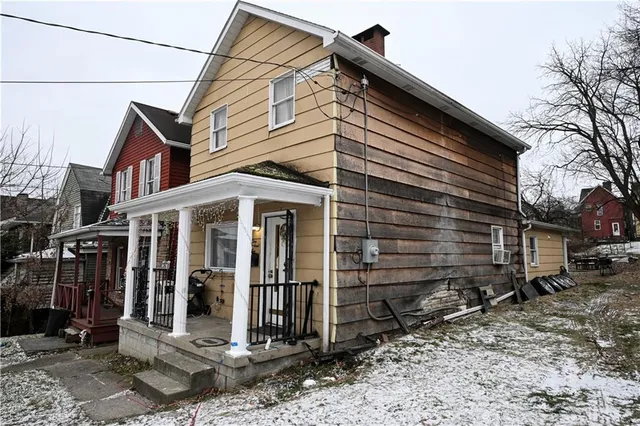 a front view of a house with outdoor seating