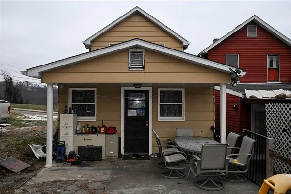 a view of a patio with a table and chairs and potted plants