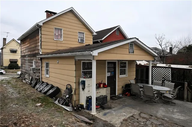 a view of a house with a yard and seating space