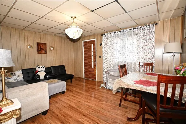 a living room with furniture wooden floor and a table