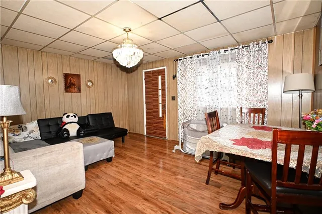 a living room with furniture wooden floor and a table