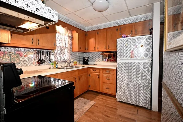 a kitchen with stainless steel appliances sink stove and cabinets
