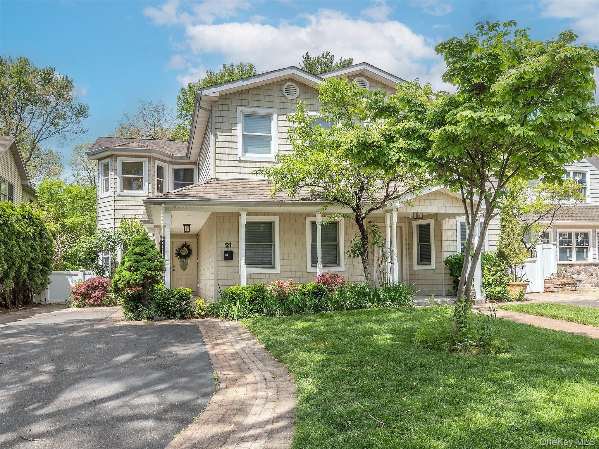 21 Marwood Road North Port Washington, NY 11050 - Photo 1 of 35 a front view of a house with a garden