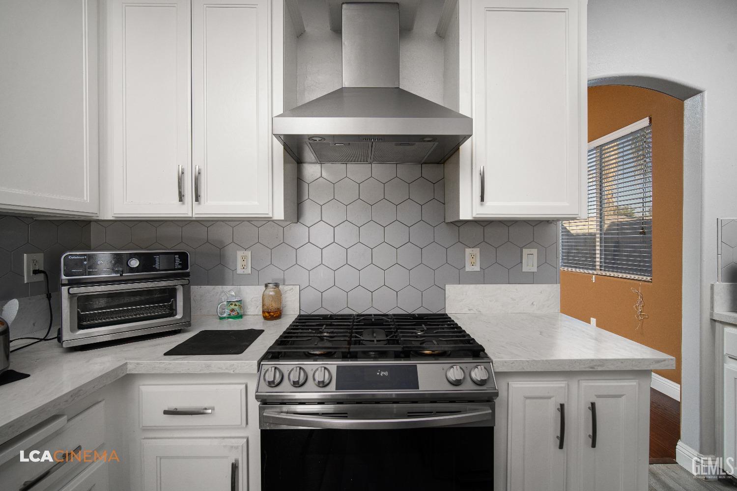 Undisclosed Address Bakersfield, CA 93311 - Photo 11 of 43 a stove top oven sitting inside of a kitchen