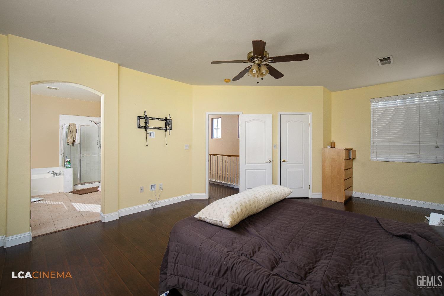 Undisclosed Address Bakersfield, CA 93311 - Photo 20 of 43 a bedroom with a large bed and a chandelier