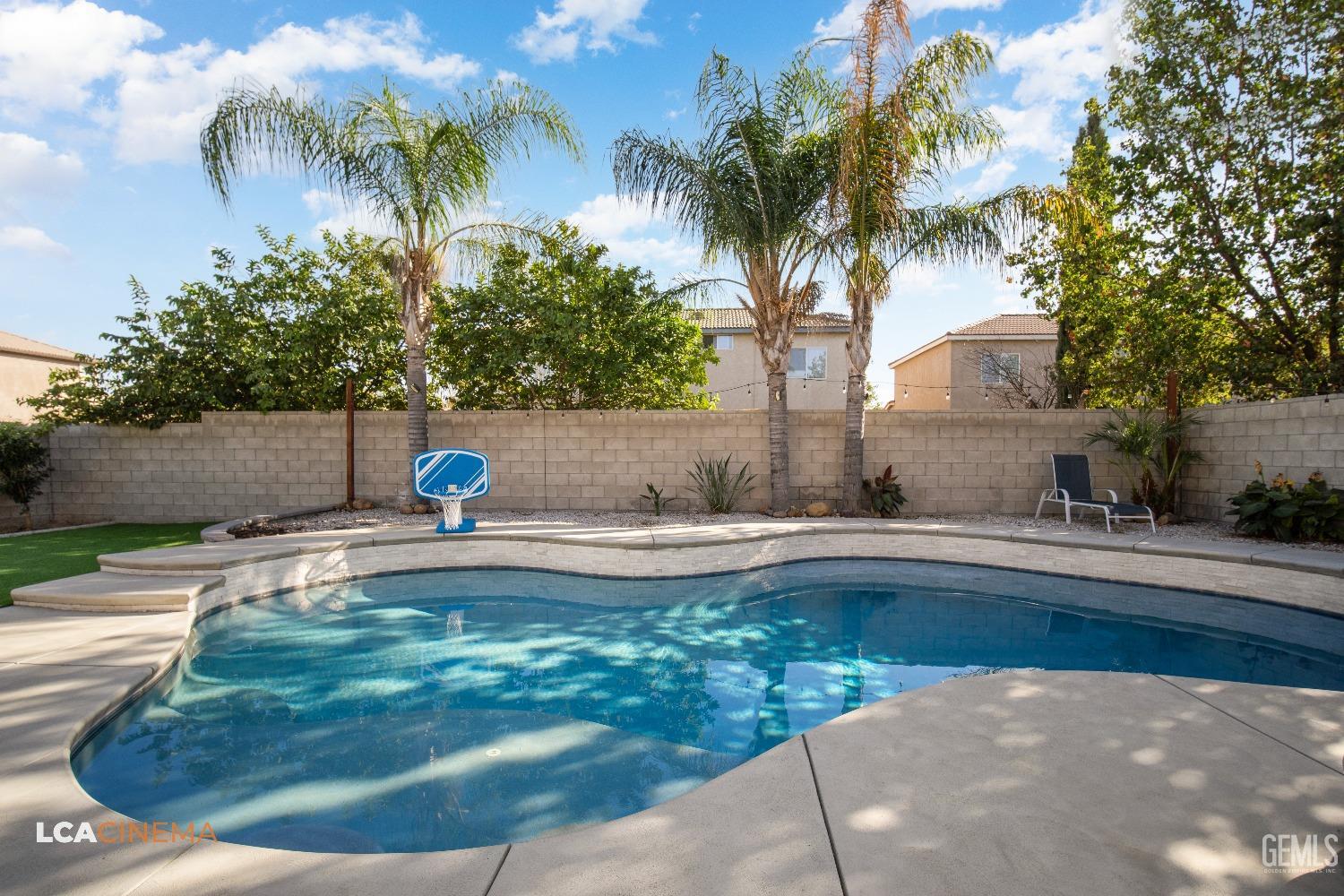 Undisclosed Address Bakersfield, CA 93311 - Photo 33 of 43 a view of a swimming pool with a yard