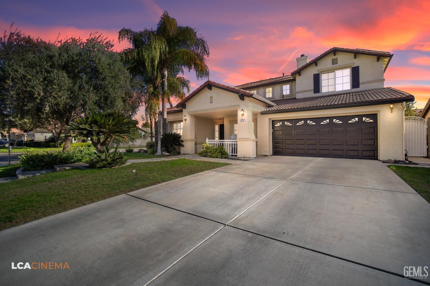 Undisclosed Address Bakersfield, CA 93311 - Photo 4 of 43 a front view of a house with a yard and garage