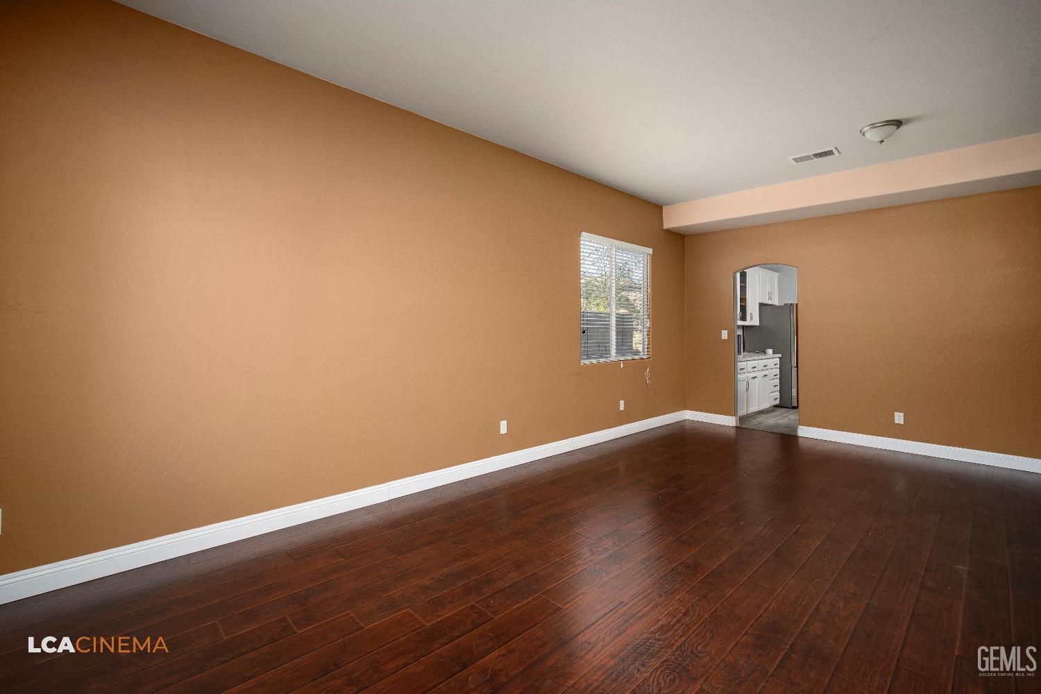 Undisclosed Address Bakersfield, CA 93311 - Photo 7 of 43 a view of an empty room with wooden floor and a window
