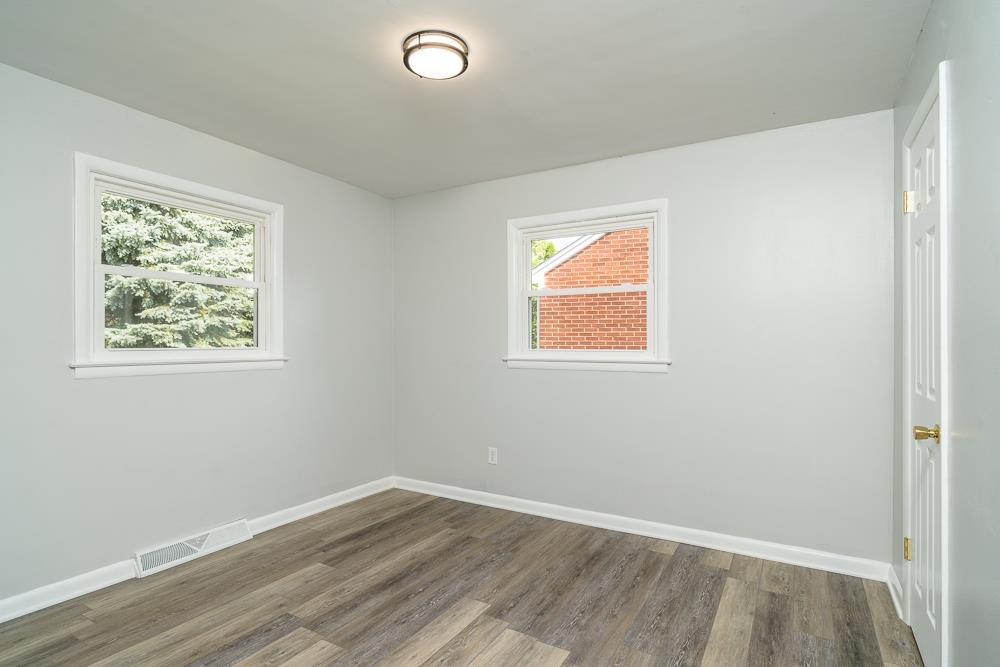 120 Robinhood Road Staunton, VA 24401 - Photo 17 of 38 an empty room with wooden floor and windows