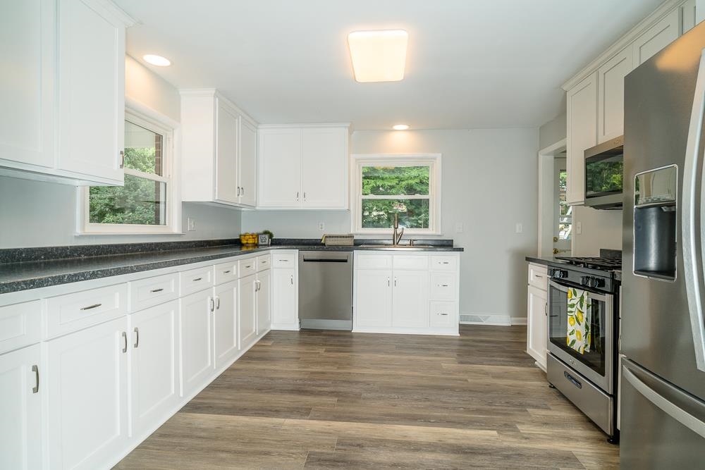120 Robinhood Road Staunton, VA 24401 - Photo 3 of 38 a kitchen with granite countertop white cabinets and white appliances