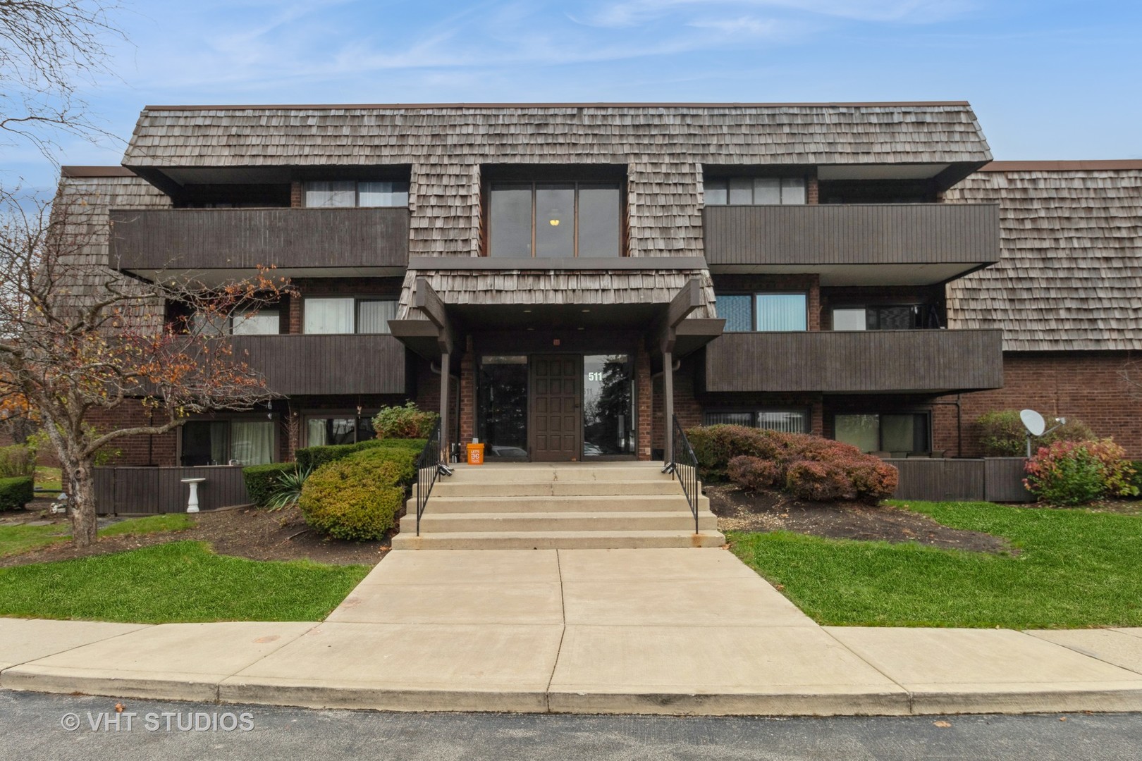 511 Timber Ridge Drive, Unit 304C Carol Stream, IL 60188 - Photo 1 of 12 a front view of a house with a garden