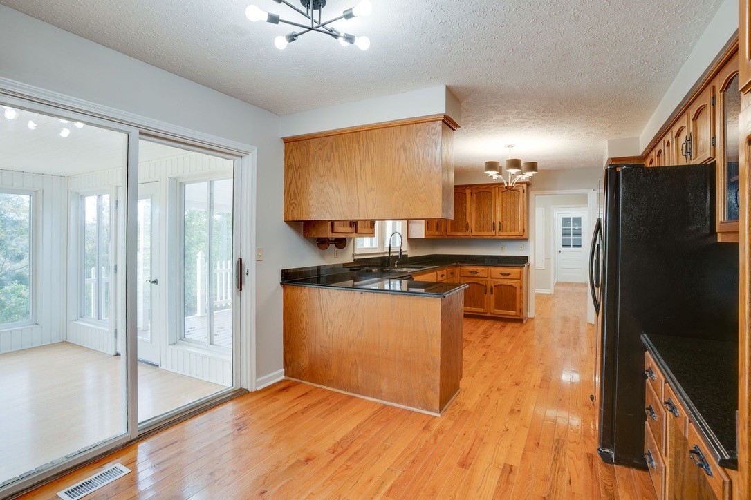 418 Spout Spring Road Dover, TN 37058 - Photo 13 of 36 a kitchen with stainless steel appliances granite countertop a refrigerator a stove and a sink