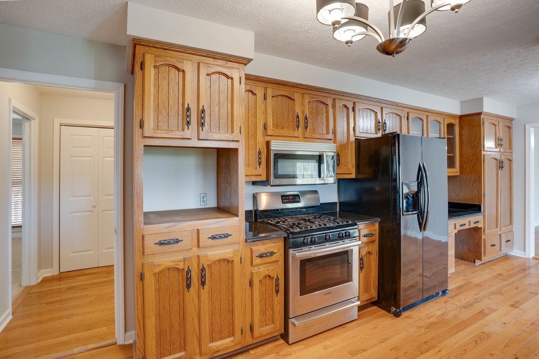 418 Spout Spring Road Dover, TN 37058 - Photo 15 of 36 a kitchen with stainless steel appliances granite countertop a refrigerator stove and sink