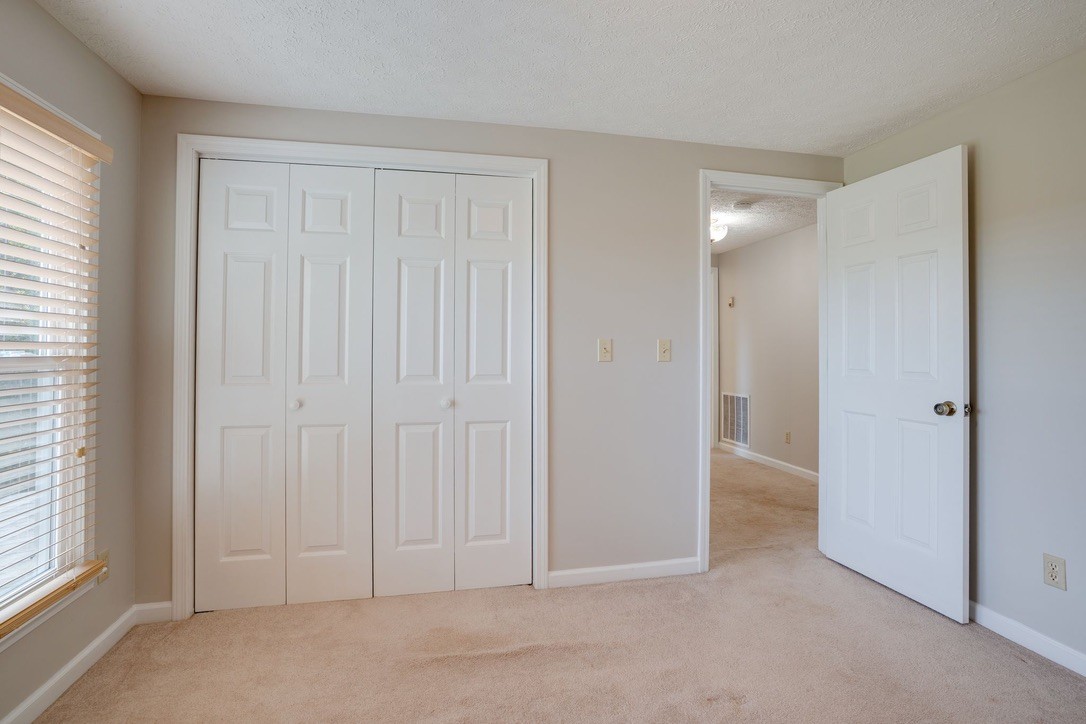 418 Spout Spring Road Dover, TN 37058 - Photo 21 of 36 an empty room with windows and closet area
