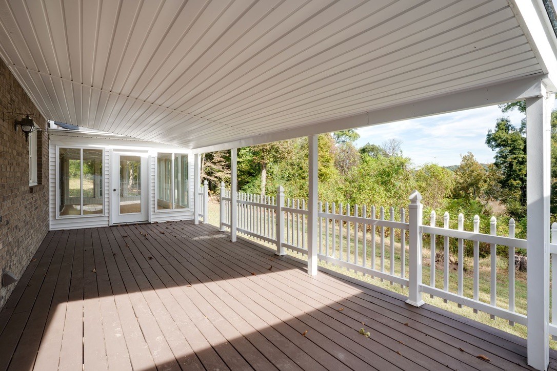 418 Spout Spring Road Dover, TN 37058 - Photo 29 of 36 a view of backyard with wooden floor and floor to ceiling window