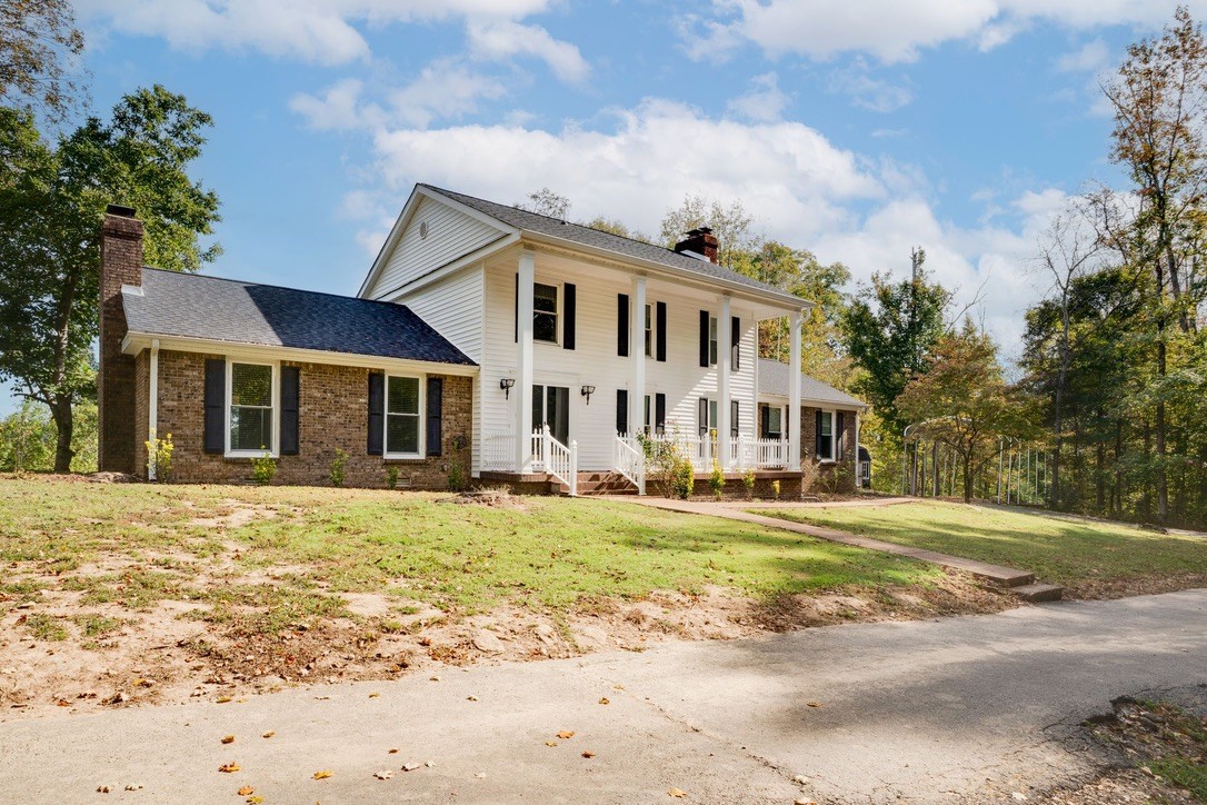 418 Spout Spring Road Dover, TN 37058 - Photo 6 of 36 a front view of a house with a garden