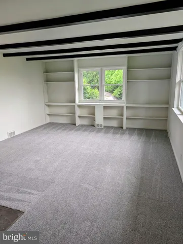 a view of room with window and an empty room