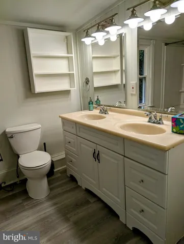 a bathroom with a toilet sink and mirror