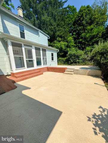 a view of pool with large windows and plants