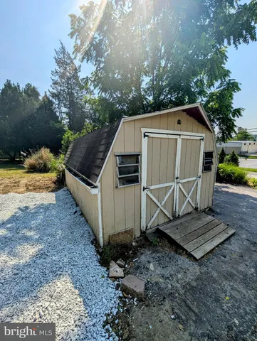 a view of backyard with wooden fence and trees