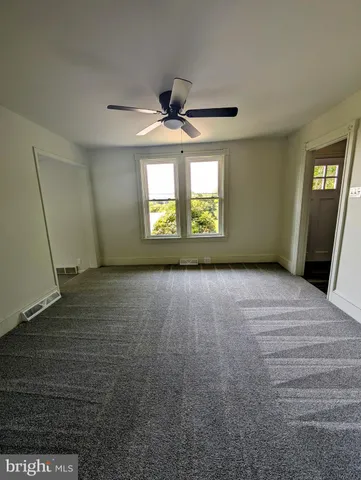 an empty room with a empty space and windows